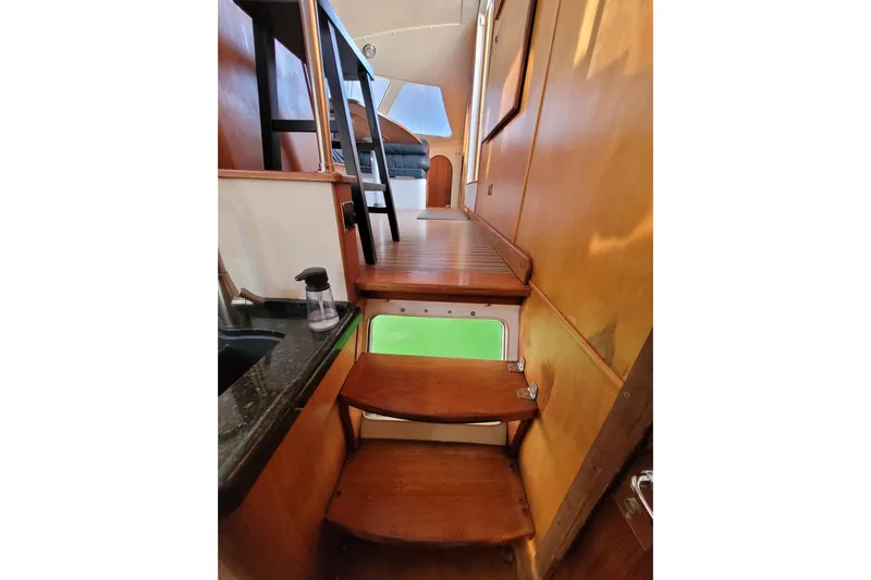 Ki Zen Yacht Photos Pics Interior of 1995 Lagoon TPI yacht with wooden stairs and modern design elements.