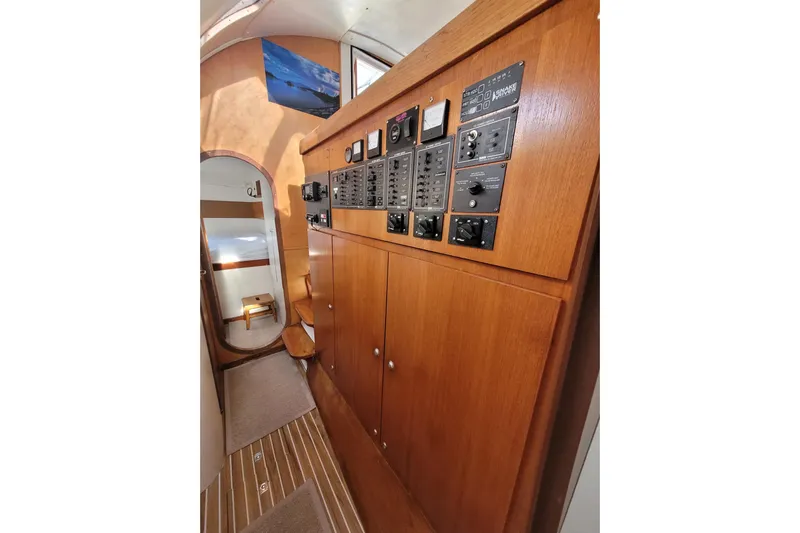 Ki Zen Yacht Photos Pics Interior of 1995 Lagoon TPI yacht with wooden paneling and control switches.