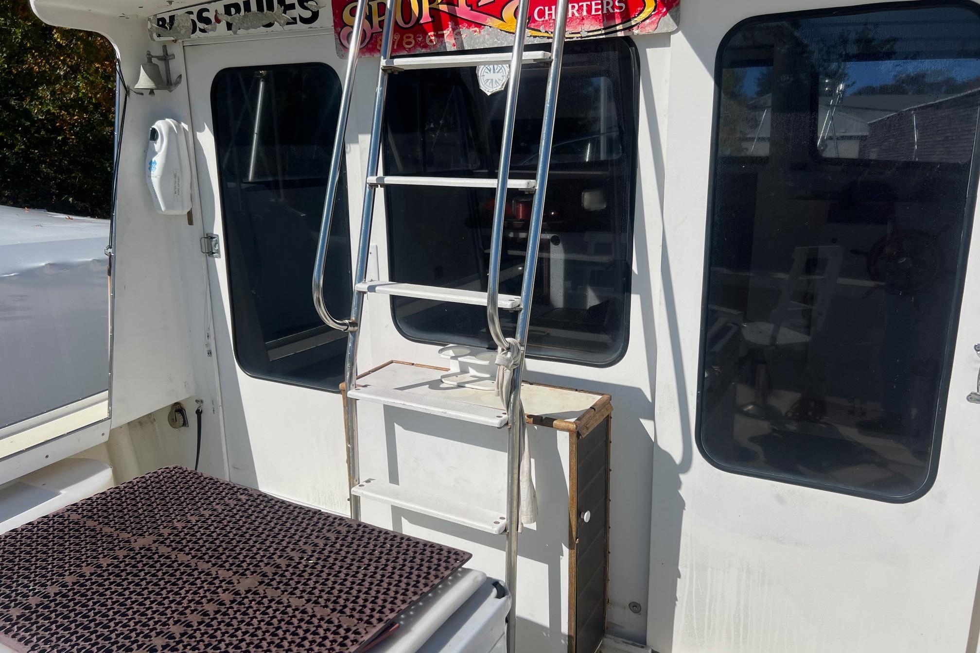 1995 Young Brothers 38 Fly Bridge boat with ladder and windows.