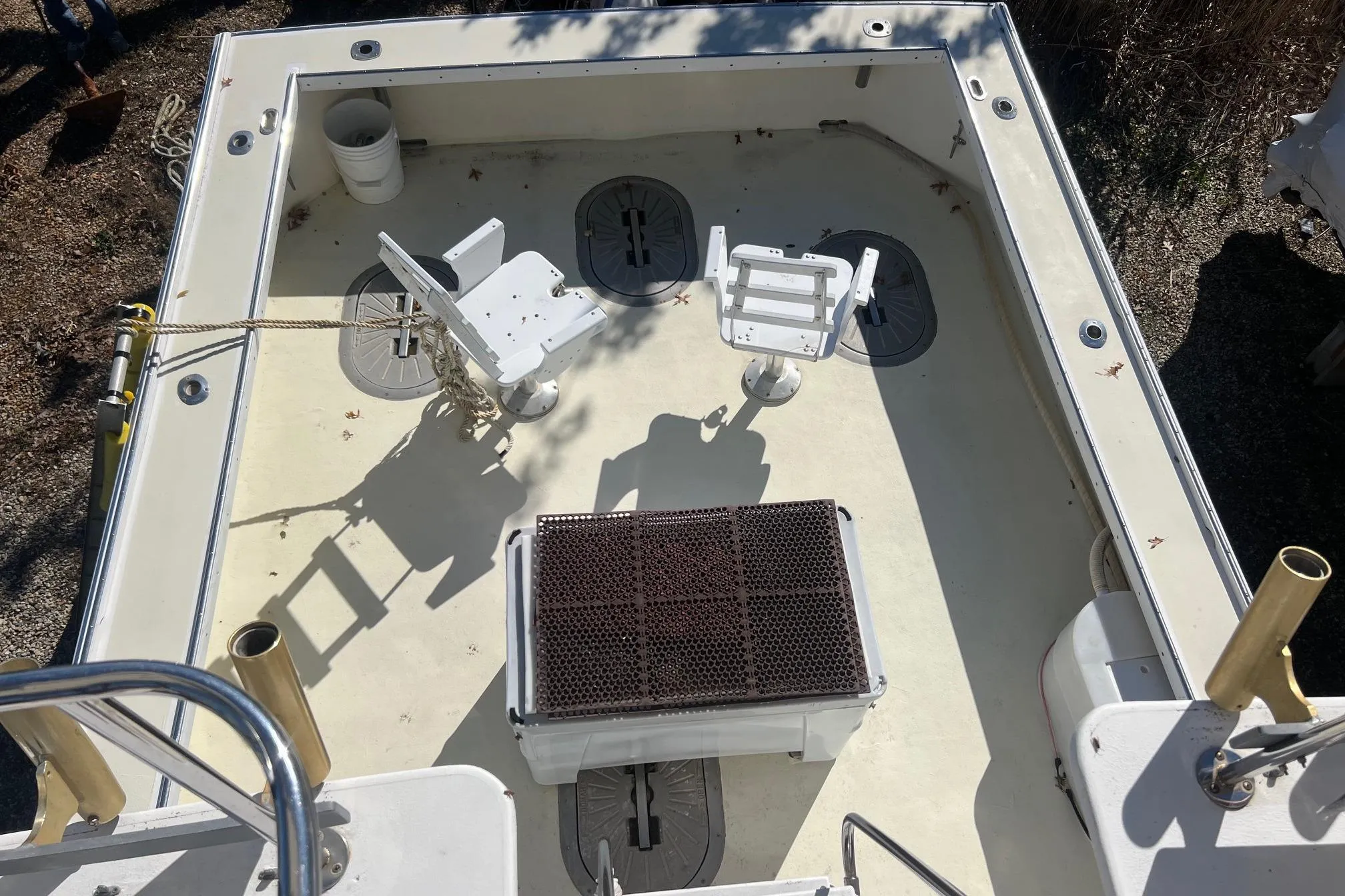 Deck view of 1995 Young Brothers 38 Fly Bridge boat with fishing chairs and equipment.
