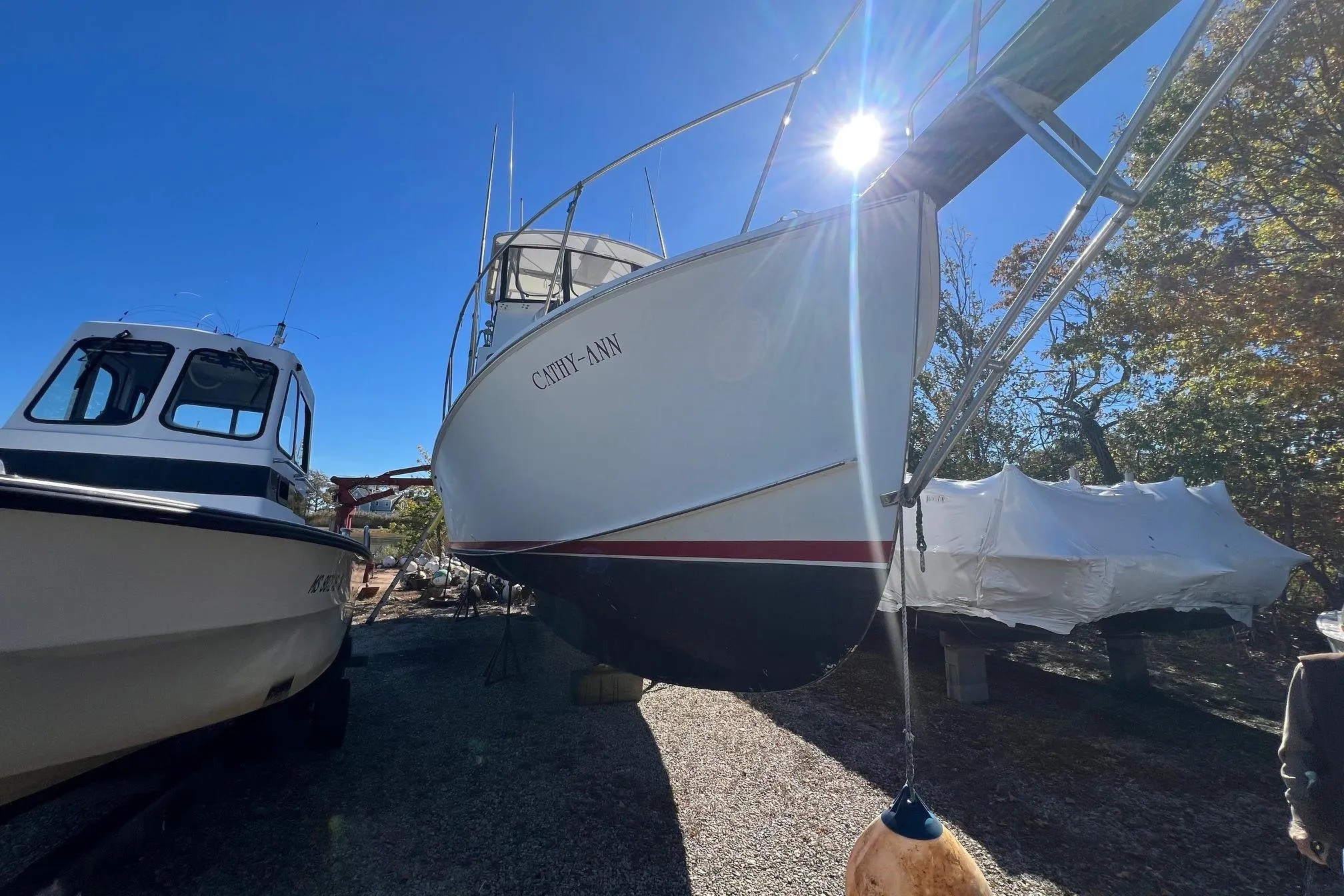 1995 Young Brothers 38 Fly Bridge boat on land, sunny day, clear sky.