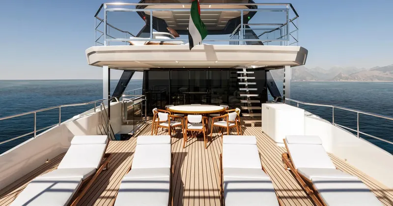 Build To Order Yacht Photos Pics Luxurious 2026 Majesty 112 Terrace yacht deck with sun loungers and dining area.