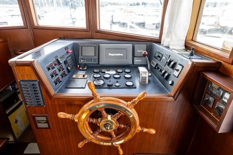 Zeta Yacht Photos Pics 2009 Diesel Duck 41-Plus helm with wooden wheel and navigation controls.