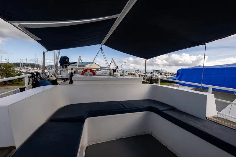 Zeta Yacht Photos Pics Diesel Duck 41-Plus 2009 boat deck with seating and canopy in marina.