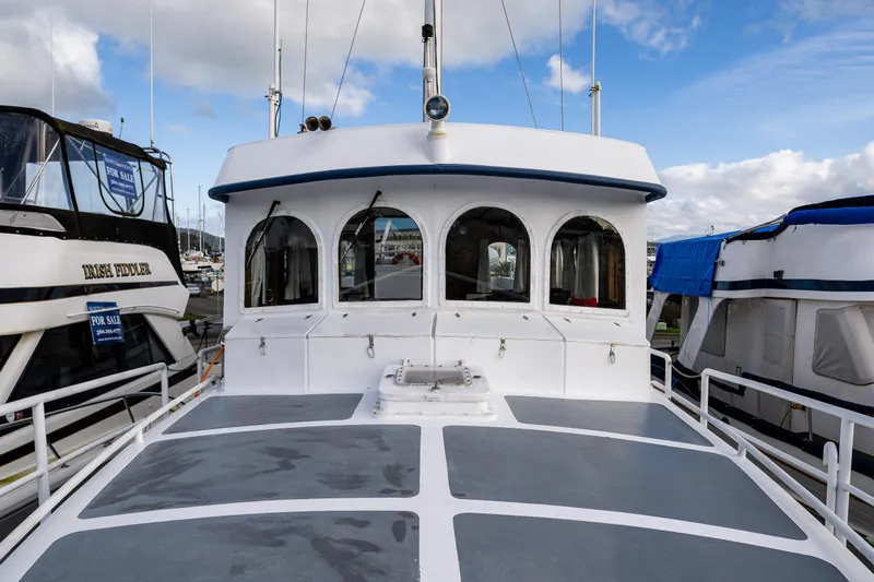 Zeta Yacht Photos Pics 2009 Diesel Duck 41-Plus boat docked, showcasing its cabin and deck under a blue sky.