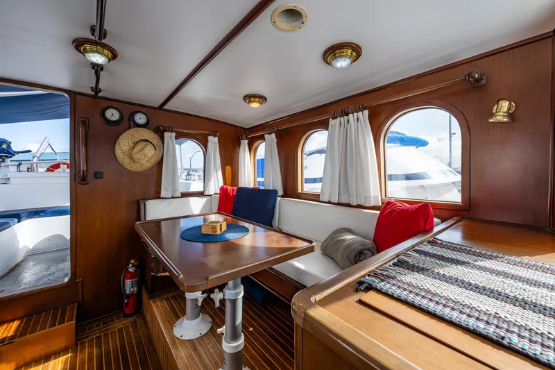 Zeta Yacht Photos Pics Interior of 2009 Diesel Duck 41-Plus yacht with wooden decor and seating area.