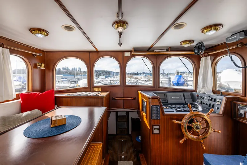 Zeta Yacht Photos Pics Interior of 2009 Diesel Duck 41-Plus boat, featuring wooden helm and panoramic windows.