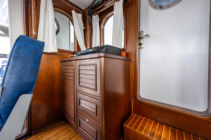 Zeta Yacht Photos Pics Interior of 2009 Diesel Duck 41-Plus boat with wooden cabinetry and seating.