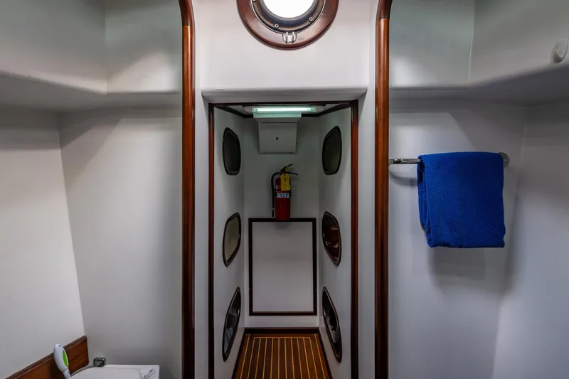 Zeta Yacht Photos Pics Interior of 2009 Diesel Duck 41-Plus yacht, featuring a hallway with wooden accents and a towel rack.