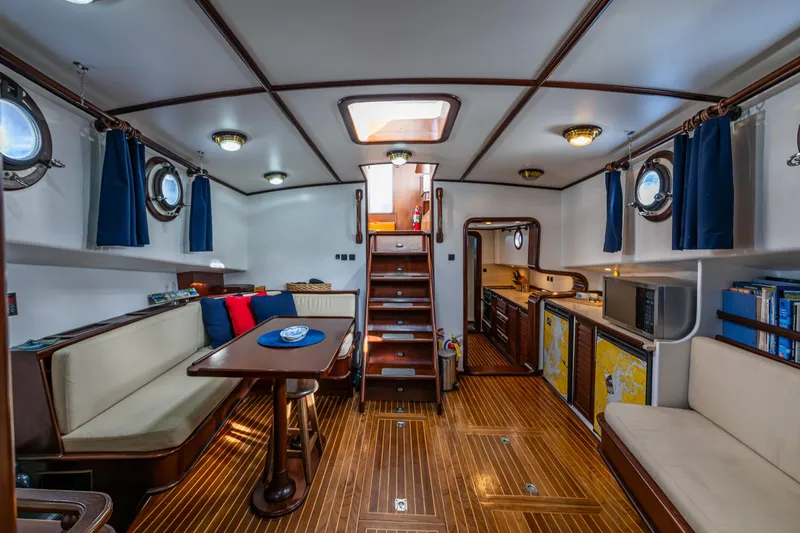 Zeta Yacht Photos Pics Interior of 2009 Diesel Duck 41-Plus yacht with wooden flooring and cozy seating area.