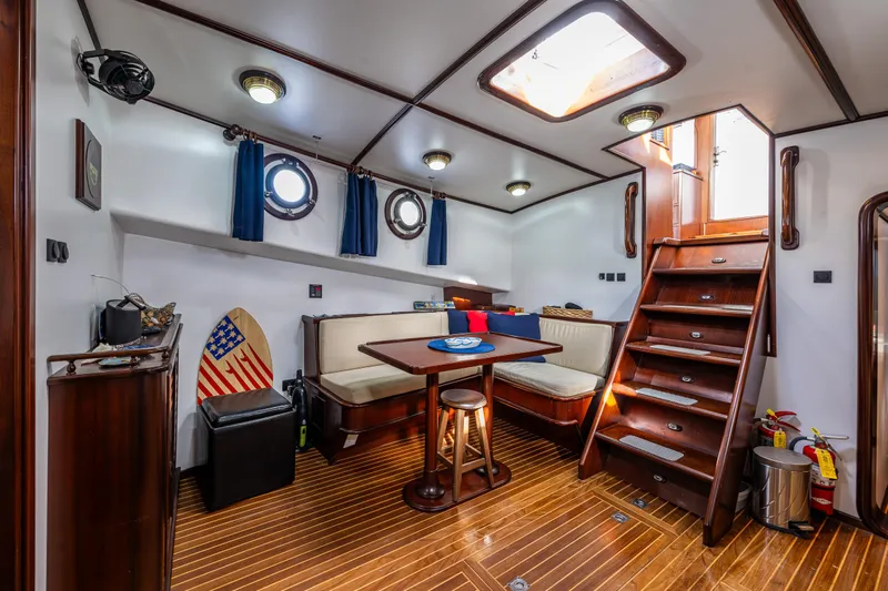 Zeta Yacht Photos Pics Interior of 2009 Diesel Duck 41-Plus yacht with wooden flooring and cozy seating area.