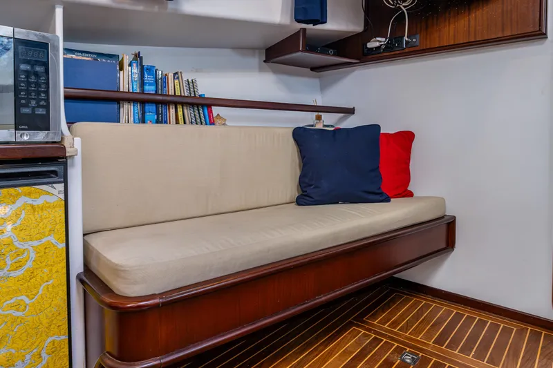 Zeta Yacht Photos Pics Cozy interior of 2009 Diesel Duck 41-Plus with cushioned seating and bookshelves.