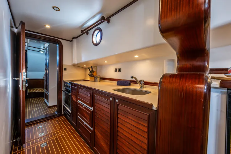 Zeta Yacht Photos Pics Luxurious 2009 Diesel Duck 41-Plus yacht interior with elegant wooden cabinetry and modern amenities.