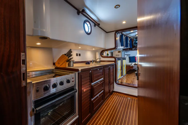 Zeta Yacht Photos Pics Luxurious 2009 Diesel Duck 41-Plus yacht kitchen with modern appliances and wood finishes.