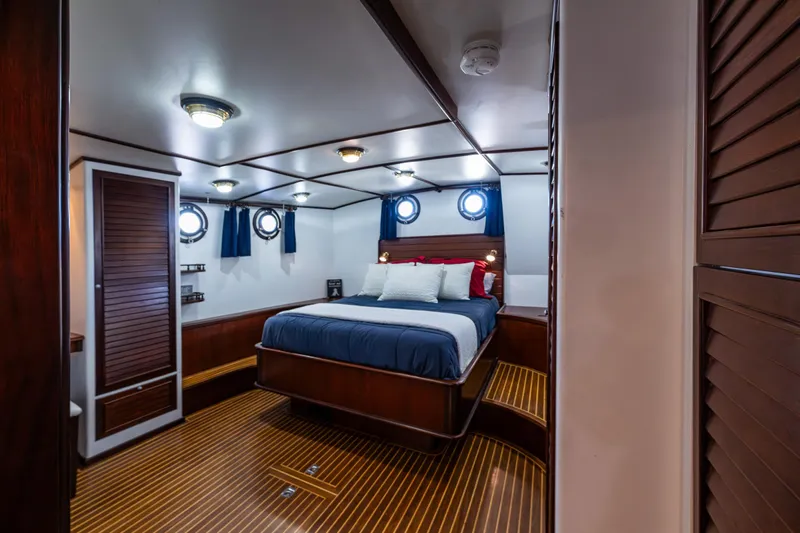 Zeta Yacht Photos Pics Luxurious cabin interior of 2009 Diesel Duck 41-Plus yacht with wood accents and cozy bed.