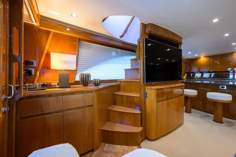 Osh-it Yacht Photos Pics Luxurious interior of 2014 Viking 76 Enclosed Bridge Convertible yacht with wooden finishes.