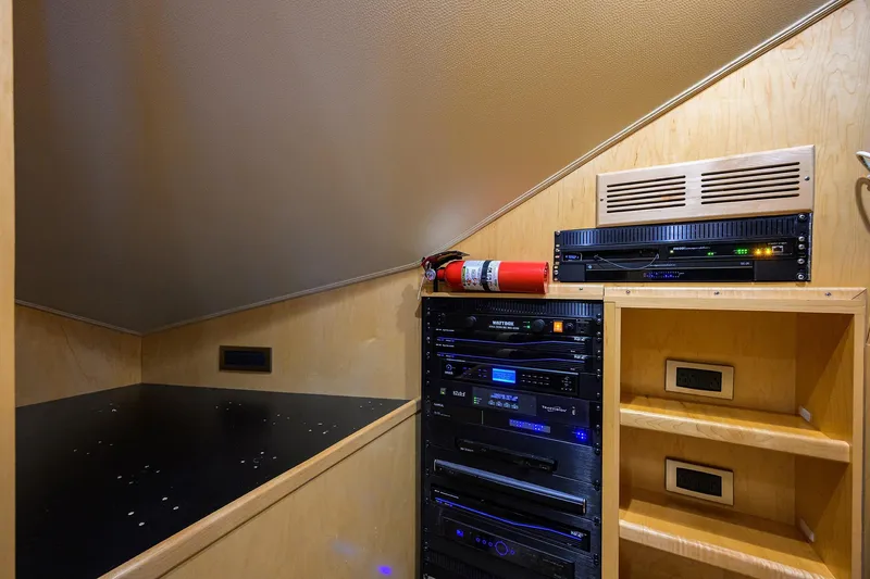 Osh-it Yacht Photos Pics 2014 Viking 76 Enclosed Bridge Convertible yacht interior with electronic equipment and fire extinguisher.