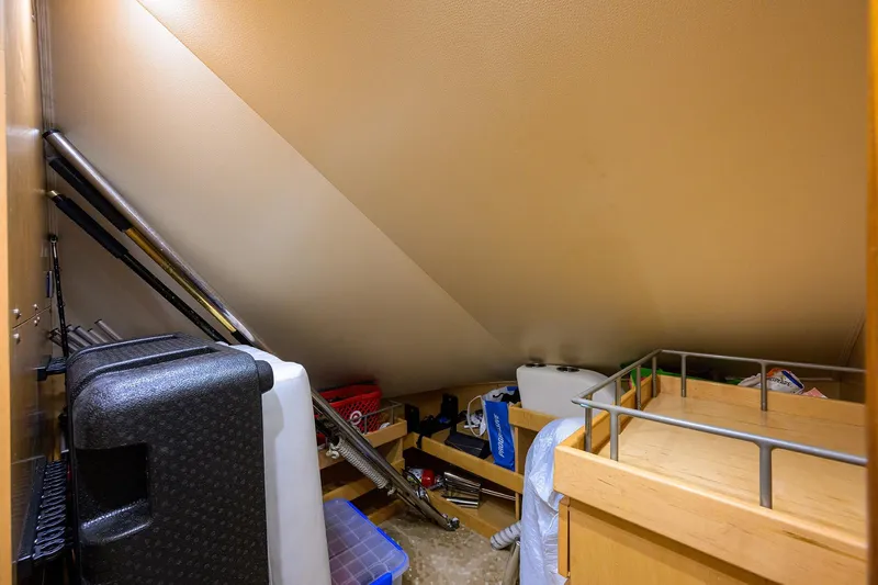 Osh-it Yacht Photos Pics Storage area inside 2014 Viking 76 Enclosed Bridge Convertible yacht, featuring various equipment and supplies.