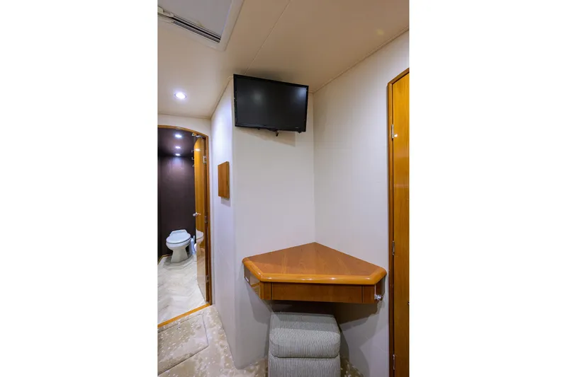 Osh-it Yacht Photos Pics 2014 Viking 76 Enclosed Bridge Convertible interior with TV, desk, and bathroom.