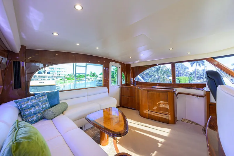 Osh-it Yacht Photos Pics Luxurious interior of 2014 Viking 76 Enclosed Bridge Convertible yacht with plush seating and elegant design.