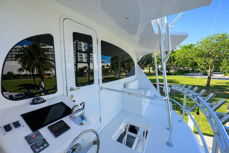 Osh-it Yacht Photos Pics 2014 Viking 76 Enclosed Bridge Convertible yacht helm with modern controls and scenic view.