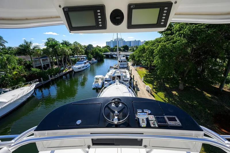 Osh-it Yacht Photos Pics View from 2014 Viking 76 Enclosed Bridge Convertible yacht, overlooking marina and lush greenery.