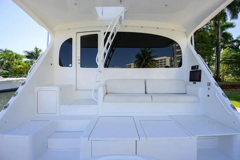Osh-it Yacht Photos Pics 2014 Viking 76 Enclosed Bridge Convertible yacht interior with white seating and modern design.