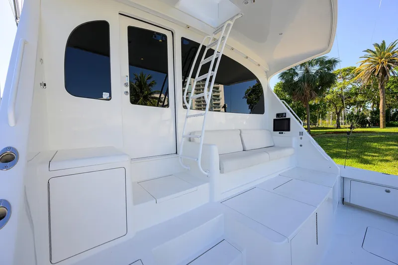Osh-it Yacht Photos Pics 2014 Viking 76 Enclosed Bridge Convertible yacht with white seating and outdoor view.