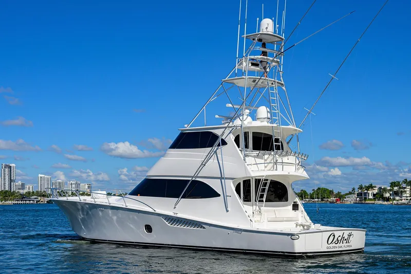 Osh-it Yacht Photos Pics 2014 Viking 76 Enclosed Bridge Convertible yacht cruising on a sunny day.