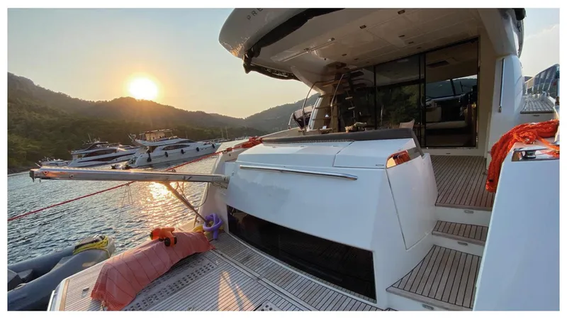  Yacht Photos Pics Luxury 2016 Prestige 620 yacht docked at sunset, with scenic mountain backdrop.