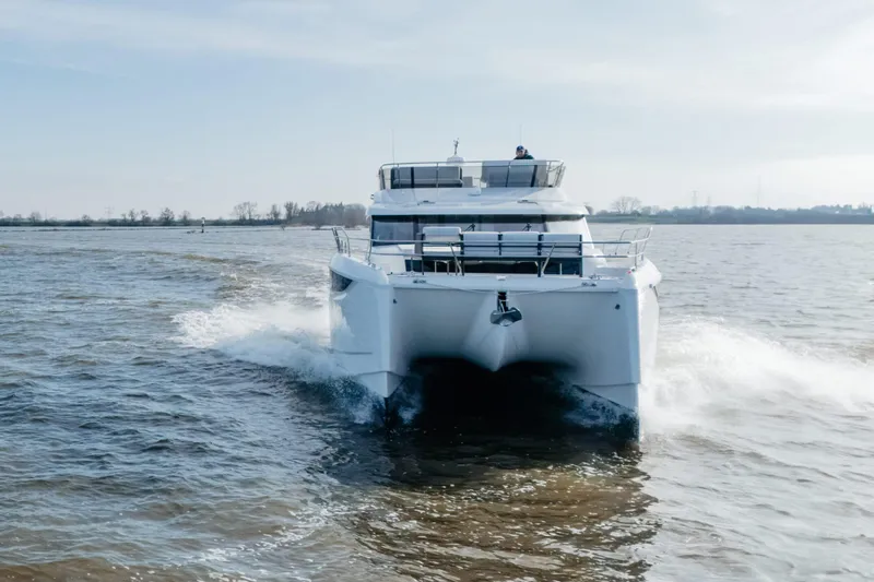  Yacht Photos Pics 2023 Prestige M48 Power Catamaran cruising on open water, front view.