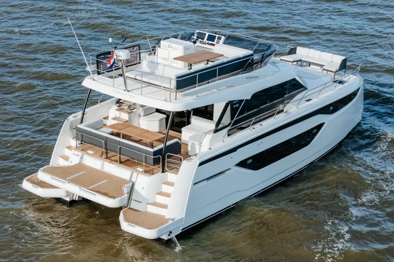  Yacht Photos Pics 2023 Prestige M48 Power Catamaran cruising on open water, showcasing luxury design and spacious decks.