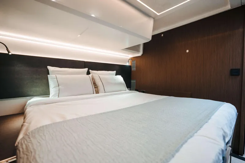  Yacht Photos Pics Luxurious bedroom interior of 2023 Prestige M48 Power Catamaran with modern lighting and elegant bedding.