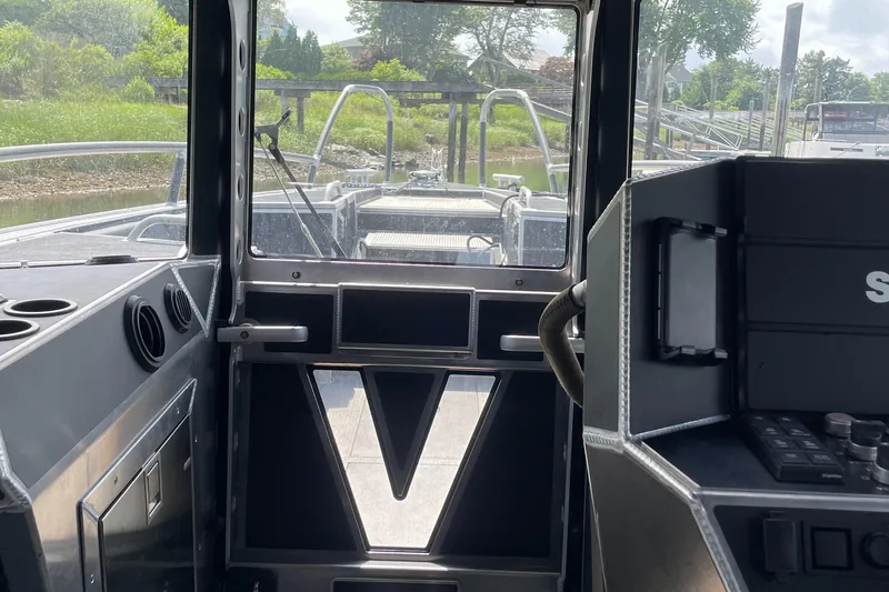  Yacht Photos Pics Interior view of 2024 Viggo C10 boat cockpit with control panel and windows.