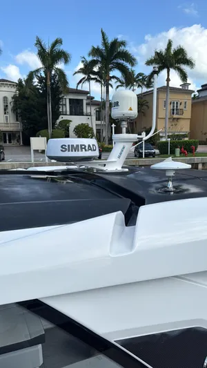  Yacht Photos Pics 2021 Cruisers Yachts 42 GLS with Simrad radar, docked near luxury homes and palm trees.