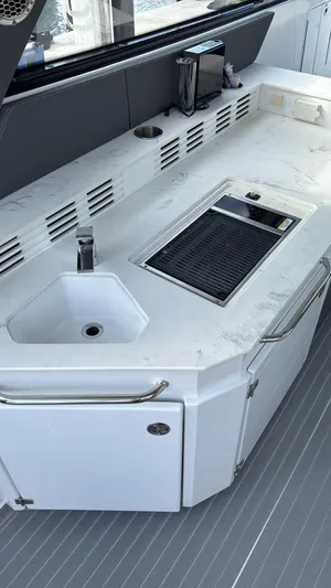  Yacht Photos Pics 2021 Cruisers Yachts 42 GLS boat kitchen with sink and grill on white countertop.