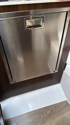  Yacht Photos Pics Stainless steel appliance in 2021 Cruisers Yachts 42 GLS interior, featuring wood accents.