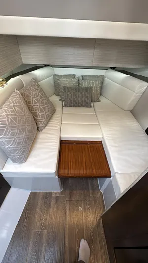  Yacht Photos Pics Interior of 2021 Cruisers Yachts 42 GLS with white seating and decorative pillows.