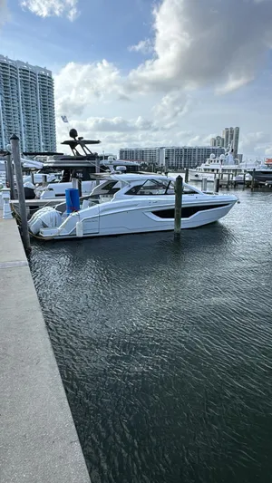  Yacht Photos Pics 2021 Cruisers Yachts 42 GLS docked at marina with cityscape background.