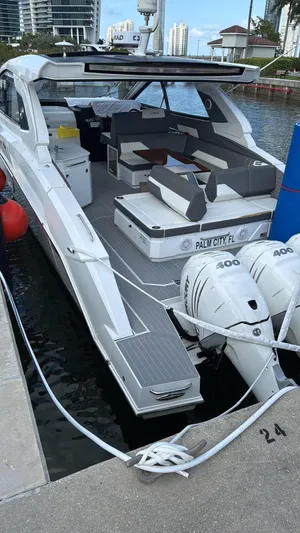  Yacht Photos Pics 2021 Cruisers Yachts 42 GLS docked, featuring spacious seating and powerful outboard engines.