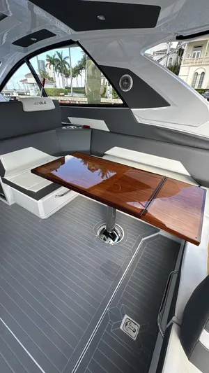  Yacht Photos Pics Interior of 2021 Cruisers Yachts 42 GLS with sleek seating and polished wooden table.
