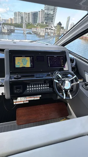  Yacht Photos Pics 2021 Cruisers Yachts 42 GLS helm with navigation screens and steering wheel, dockside view.