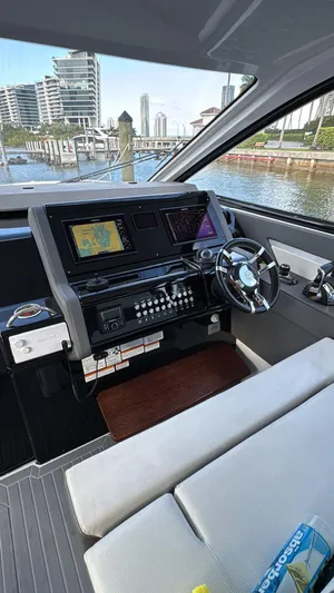  Yacht Photos Pics Helm of 2021 Cruisers Yachts 42 GLS with modern navigation equipment and waterfront view.