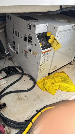  Yacht Photos Pics Engine compartment of 2021 Cruisers Yachts 42 GLS with Onan generator and caution tag.