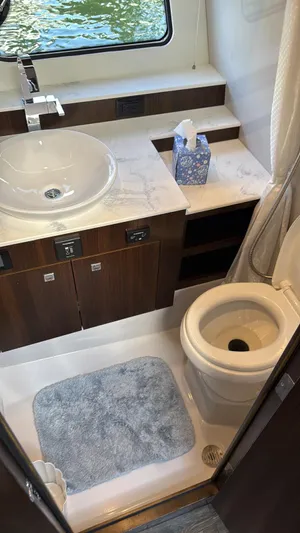  Yacht Photos Pics Bathroom interior of 2021 Cruisers Yachts 42 GLS with modern fixtures and window view.