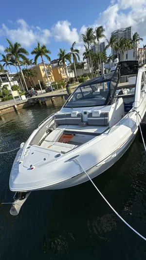  Yacht Photos Pics 2021 Cruisers Yachts 42 GLS docked near palm trees and waterfront homes.