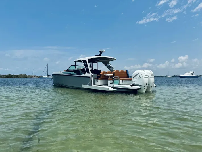  Yacht Photos Pics 2023 Saxdor 320 GTO boat in shallow water, clear sky background.