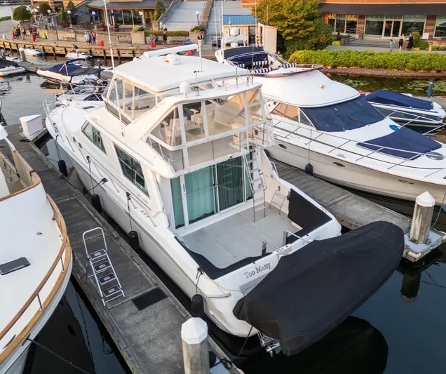 Too Many Options Yacht Photos Pics 1993 Sea Ray 550 Sedan Bridge yacht docked at marina, aerial view.
