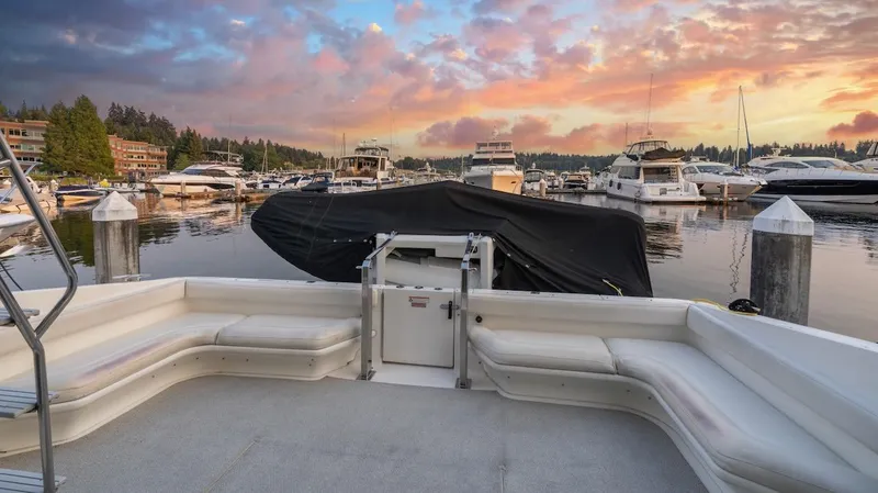 Too Many Options Yacht Photos Pics 1993 Sea Ray 550 Sedan Bridge at marina during vibrant sunset.