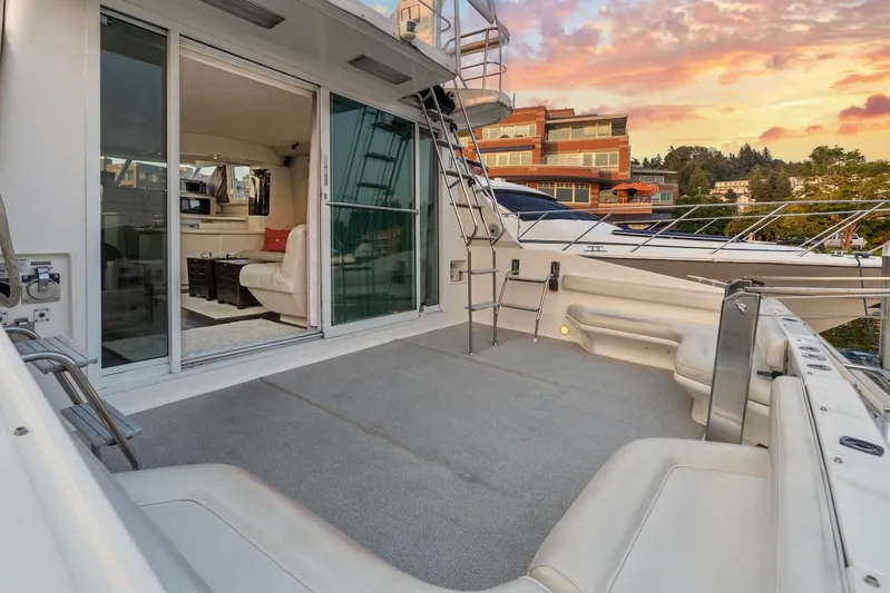 Too Many Options Yacht Photos Pics 1993 Sea Ray 550 Sedan Bridge yacht with spacious deck and luxurious interior at sunset.